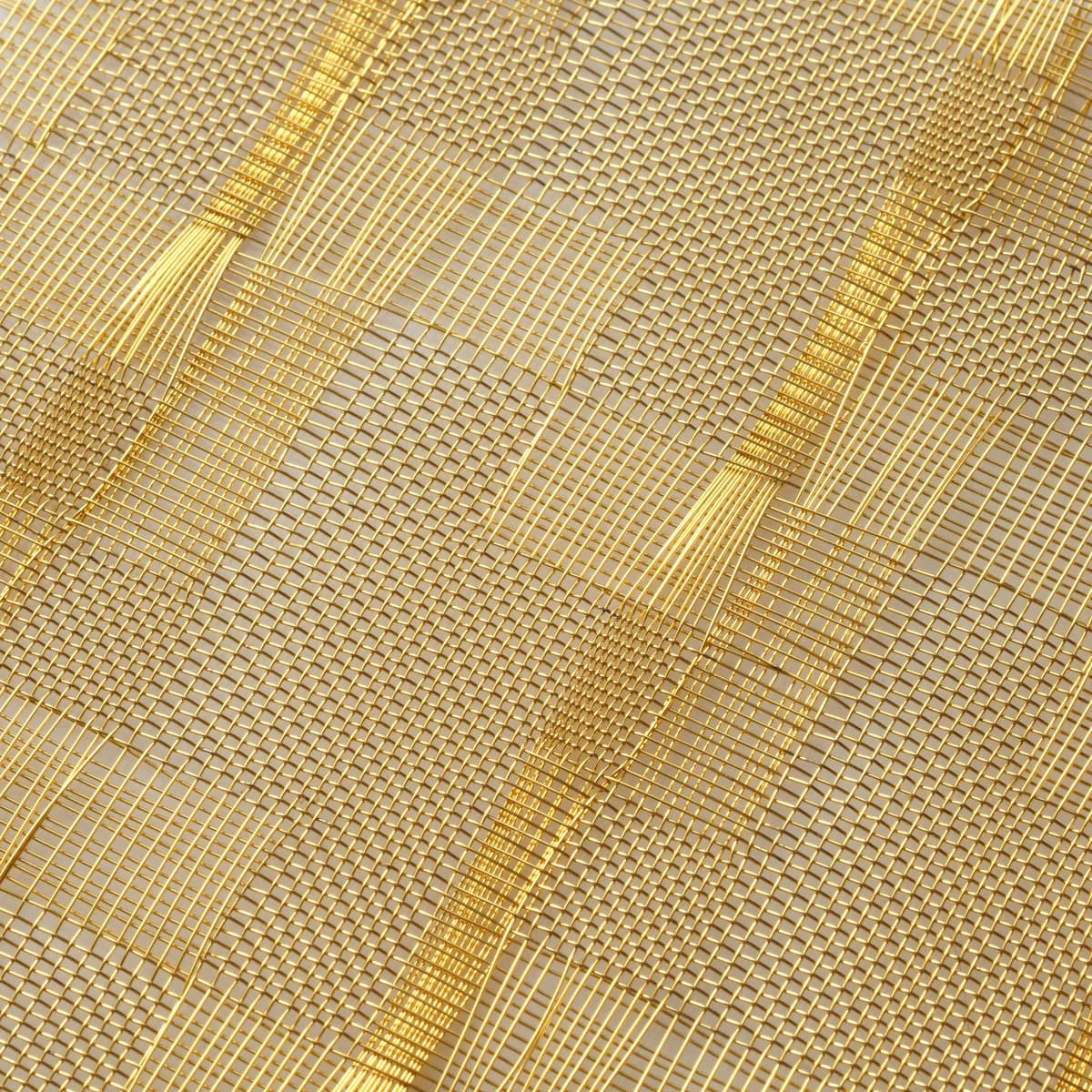 Gold-tone architectural metal mesh sample used to approve material, finish, texture and direction